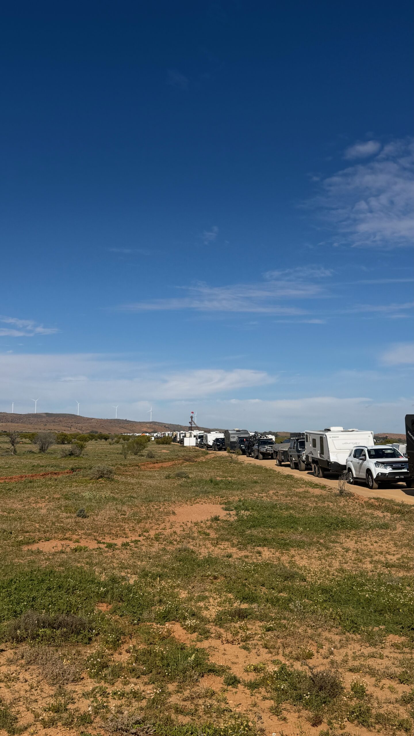 Vehicles lining up on the road into the Mundi Mundi Bash